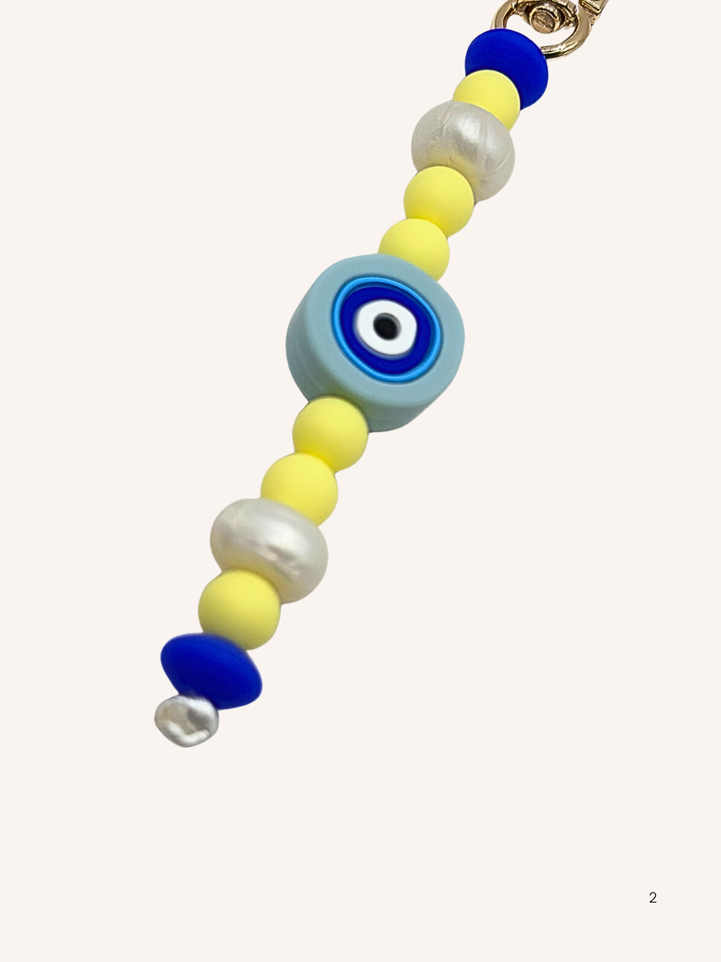 Chaîne de téléphone œil de Nazar et perles jaunes