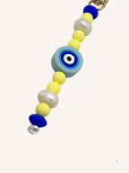 Chaîne de téléphone œil de Nazar et perles jaunes