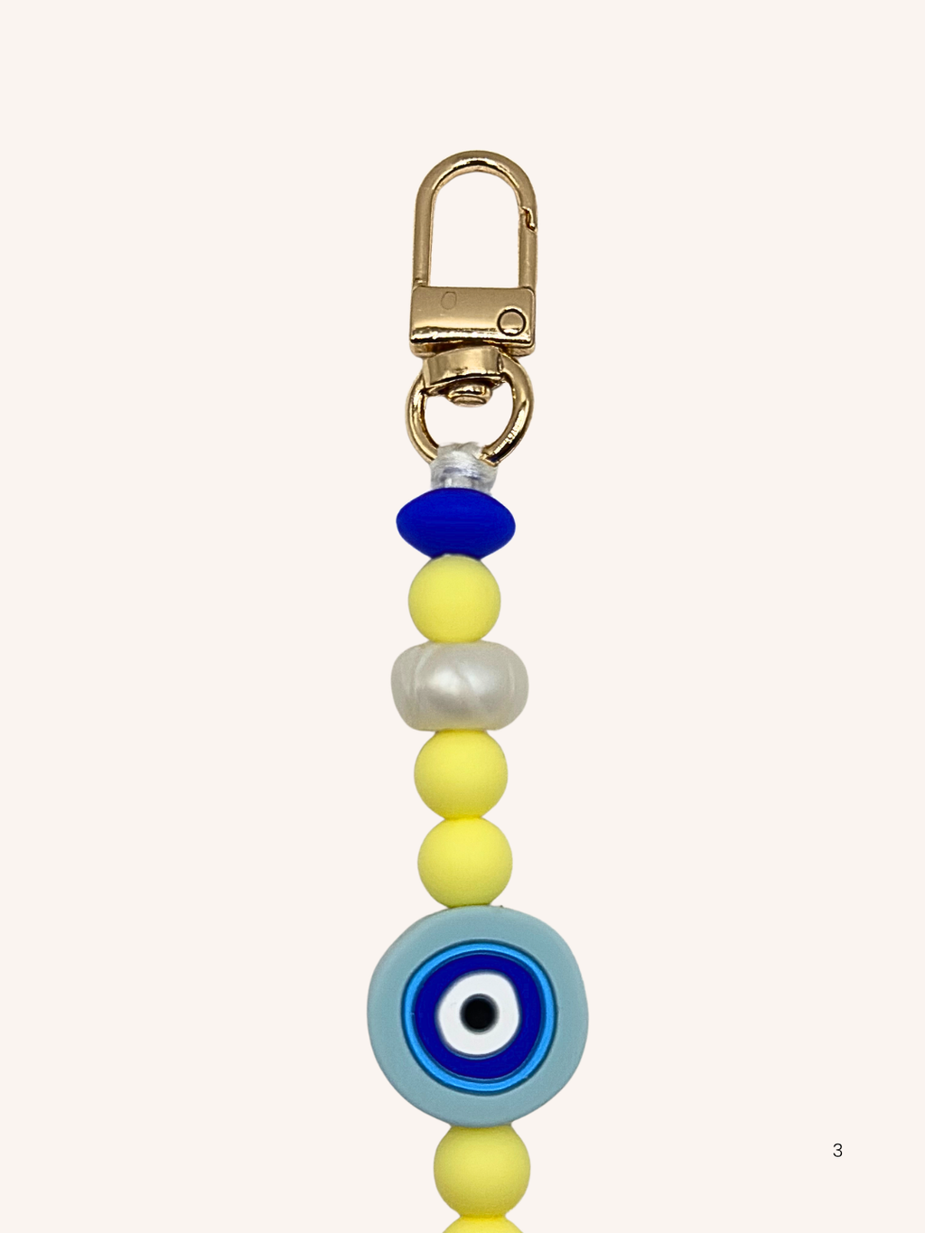 Chaîne de téléphone œil de Nazar et perles jaunes