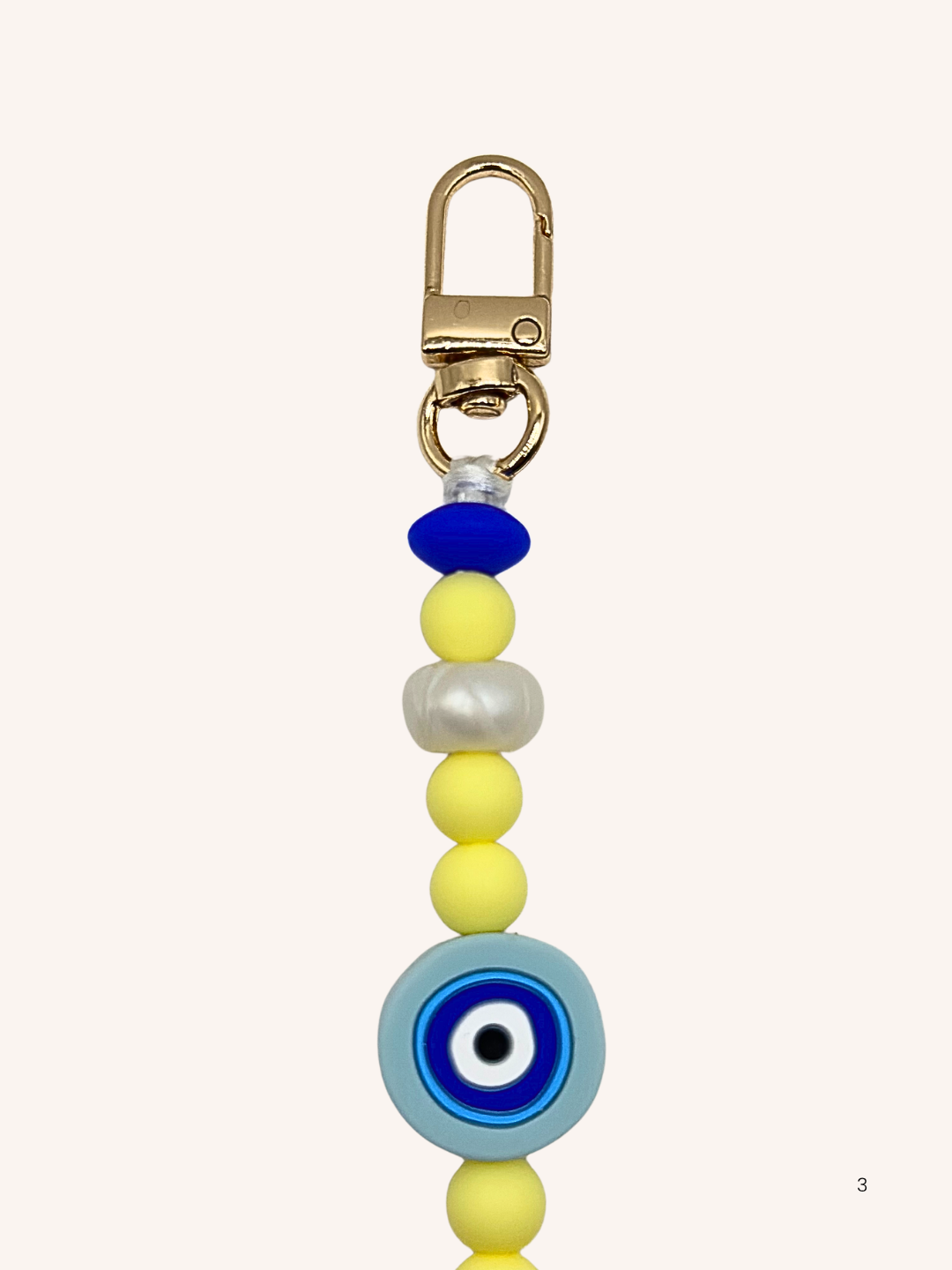 Chaîne de téléphone œil de Nazar et perles jaunes