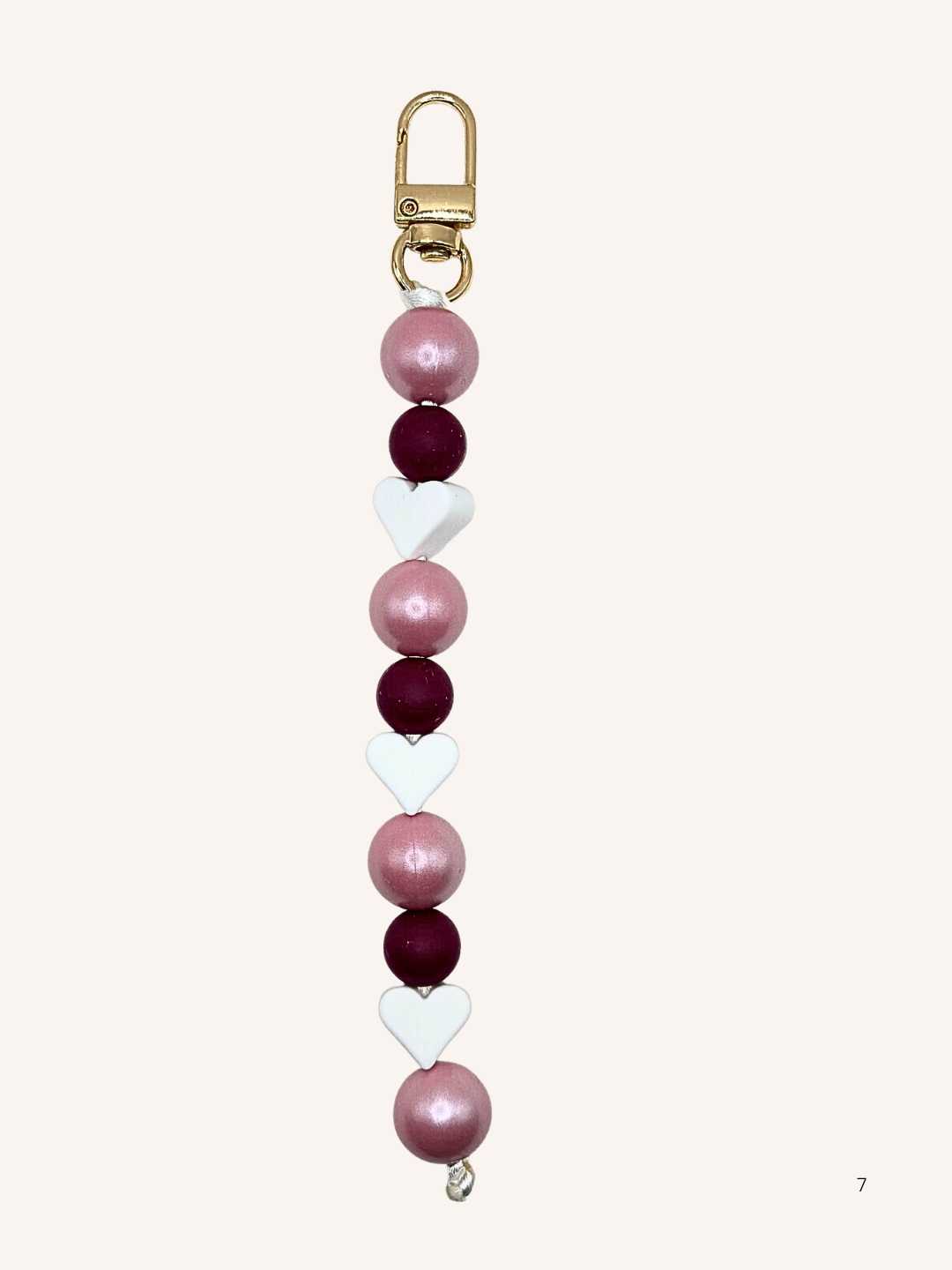 Chaîne de téléphone rose nacré et cœur blanc