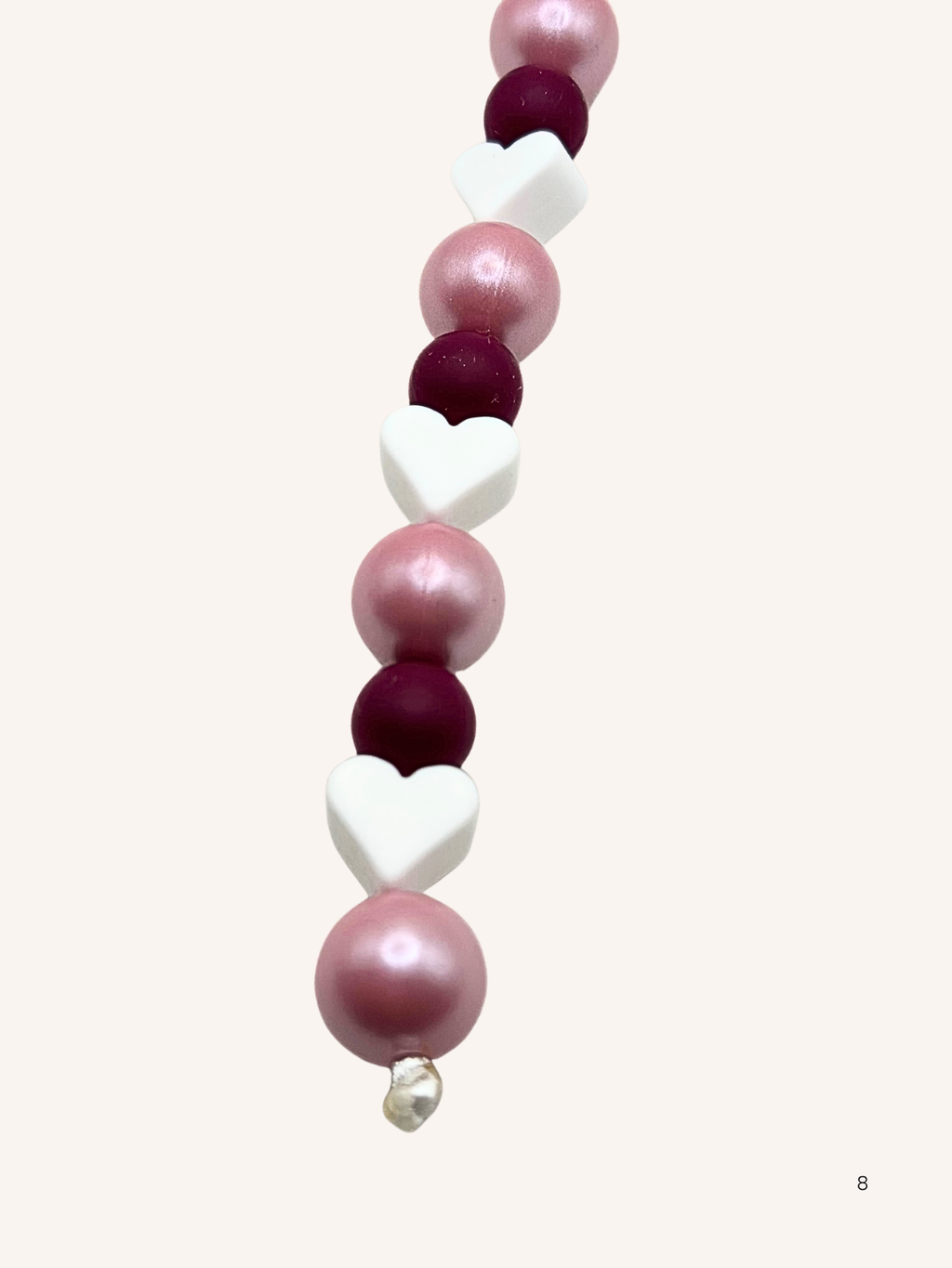 Chaîne de téléphone rose nacré et cœur blanc