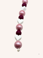 Chaîne de téléphone rose nacré et cœur blanc